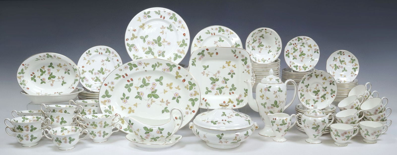 (123) WEDGWOOD 'WILD STRAWBERRY' BONE CHINA DINNER SERVICE: (lot of 123) Wedgwood bone china dinner service, in the "Wild Strawberry" pattern, with parcel gilt trim, transfer strawberries and flowering foliate vines, marker's mark underfoot, including: (12) di