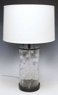 ROBERT ABBEY 'GLORIA' CONTEMPORARY DIMPLED GLASS 2-LT TABLE LAMP: Contemporary colorless art glass "Gloria" two-light table lamp, attributed to Robert Abbey, 21st c., having cylindrical hollow standard with dimpled interior, rising on circular foot, accompanied by