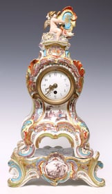 FRENCH ROCOCO STYLE PARCEL GILT FIGURAL FAIENCE CLOCK ON STAND