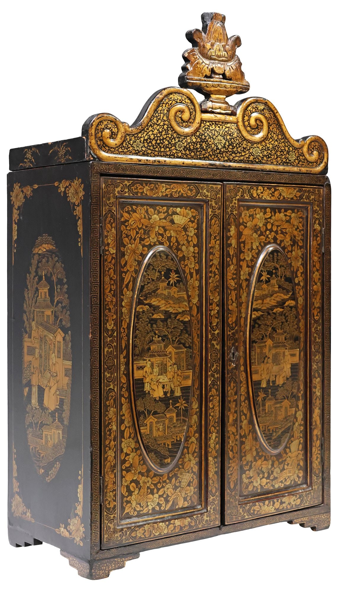 CHINESE EXPORT PARCEL-GILT LACQUER TABLETOP CABINET: Chinese export parcel-gilt lacquered miniature cabinet, having scrolled crest with foliate vinery, dual cabinet doors with ovular reserves depicting school children in a courtyard, the side panels wit