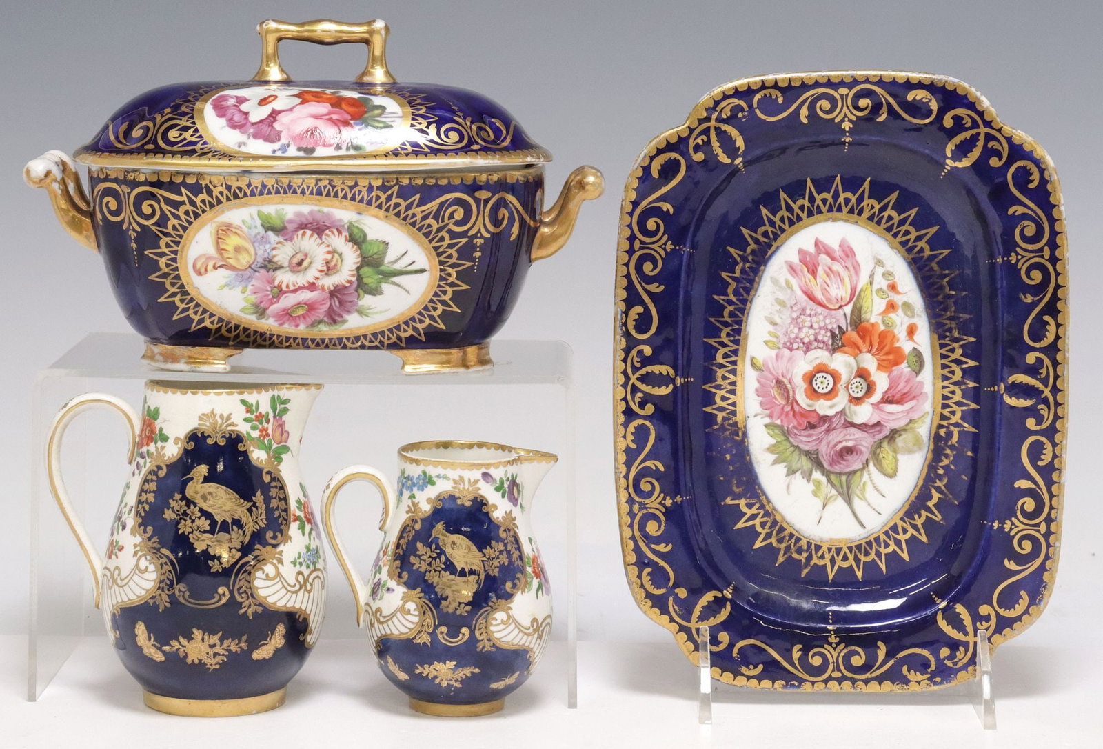 (3) ENGLISH CREAM JUGS & SAUCE TUREEN, COVER & STAND: (lot of 3) English ceramic table articles, including: (1) sauce tureen, cover and undertray, gilt cartouches painted with floral sprays, reserved on the cobalt blue ground, apparently unmarked, stable