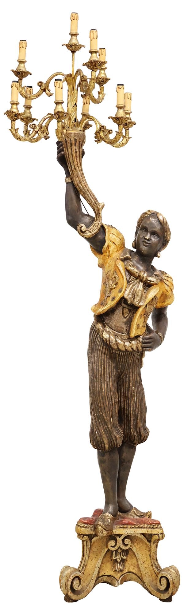 VENETIAN PARCEL-GILT & POLYCHROME-DECORATED TORCHERE: Venetian parcel-gilt and polychrome-decorated torchere, early 20th c., modeled as a figure in Moorish-style dress, holding aloft a candelabrum with ten lights in three tiers, standing on a tripod base