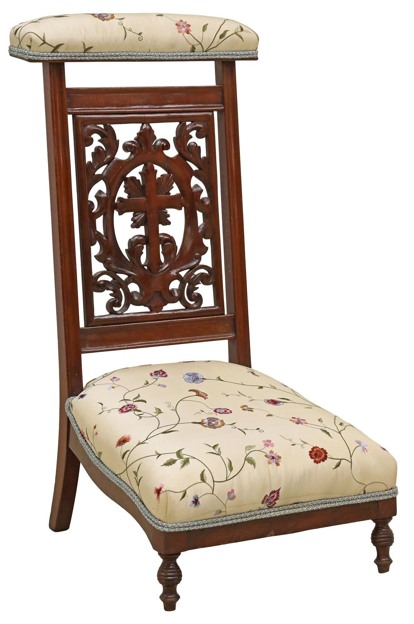 FRENCH CARVED MAHOGANY UPHOLSTERED PRIE-DIEU PRAYER KNEELER: French carved mahogany prie dieu/ prayer kneeler, 20th c., having padded top rail and seat in floral patterned upholstery, with ribbon trim, carved cross splat, rising on turned legs, small tear to up