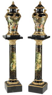 (2) SEVRES STYLE PAINTED MARBLE URNS ON PEDESTALS: (pair) Sevres style paint-decorated marble urns on pedestals, with gilt metal mounts, each having flaming torch finial, above painted scene depicting draped allegorical figures, rising on columnar sta