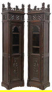 (2) FRENCH GOTHIC REVIVAL CARVED OAK BOOKCASES, 77"H: (pair) French Gothic Revival oak bookcases/ cabinets, 19th c., having twisted gallery issuing foliate-form finials, over molded cornice, the case with recessed panels of carved tracery, single glazed