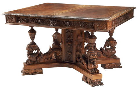 CONTINENTAL RENAISSANCE REVIVAL CARVED DINING TABLE: Continental Renaissance Revival carved wood dining table, 19th c., having rectangular top, above apron with protruding masks and scrolling foliate frieze, rising on winged grotesque supports, further