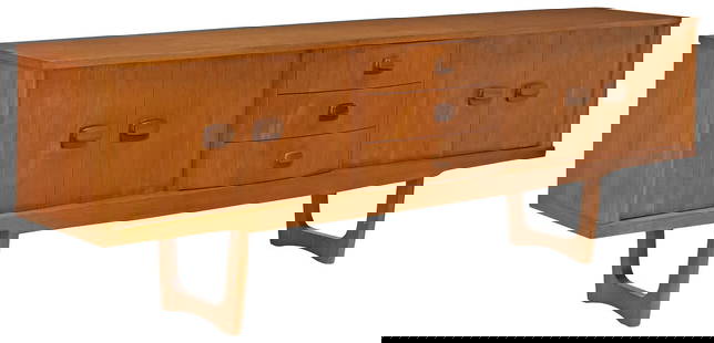STONEHILL MID-CENTURY MODERN TEAK CREDENZA SIDEBOARD: Mid-century modern teak sideboard, Stonehill Furniture Ltd., c.1960s, three centered drawers, the top drawer interior divided for flatware, flanked by bi-fold cabinet doors, the left side with a fixed
