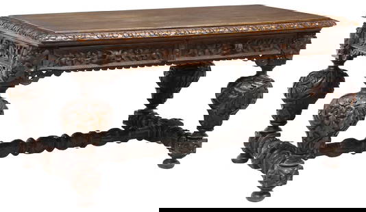 ENGLISH VICTORIAN HIGHLY CARVED OAK LIBRARY TABLE: English Victorian highly carved oak library table, late 19th c., having rectangular top with ornamental trim, apron with scrolled foliate vines, fitted with two drawers, reverse side with two faux dra
