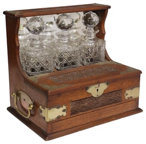 VICTORIAN BRASS-BOUND CARVED OAK TANTALUS DECANTER SET
