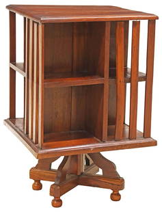 ENGLISH MAHOGANY TWO-TIER ROTATING BOOKSTAND LIBRARY STAND: English mahogany rotating bookcase, early 20th c., two tiers with slatted sides, ending on bun feet, approx 28.75&quot;h, 17 5/8&quot;w, 17 5/8&quot;d