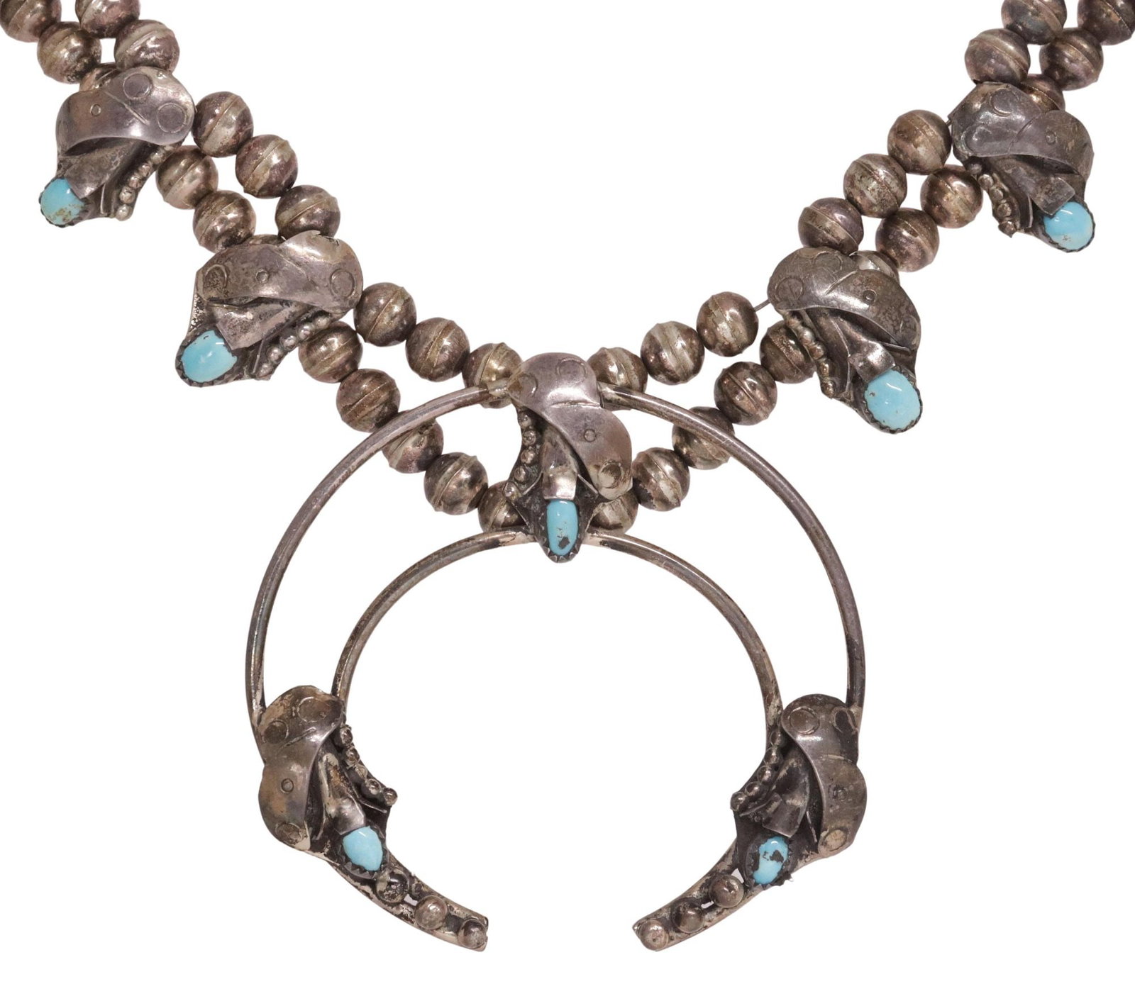 NATIVE AMERICAN TURQUOISE SQUASH BLOSSOM NECKLACE: Native American silver (content unknown) squash blossom necklace, ten blossoms, each set with a oval turquoise cabochon, central naja pendant with three additional turquoise cabochons, double ben