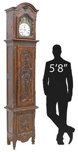 FRENCH PROVINCIAL CARVED WALNUT HARVEST MOTIF MORBIER CLOCK: French Provincial carved walnut morbier/ longcase clock, 19th c., having arched crest, over glazed dial viewing panel, white dial with Roman numeral hour markers, time-and-strike movement, central cab