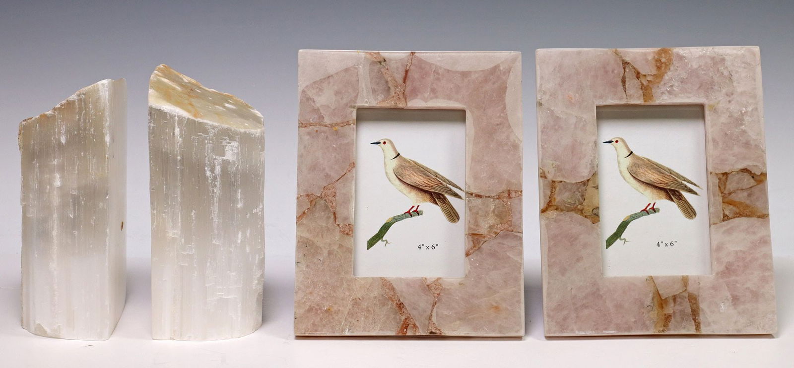 (4) PINK AGATE PICTURE FRAMES & GEOLOGICAL SELENITE BOOKENDS: (lot of 4) Natural stone cabinet or table articles, including: (pair) Creative Co-op pink agate picture frames, designed to accommodate a 4" by 6" image, one retaining adhesive maker's l