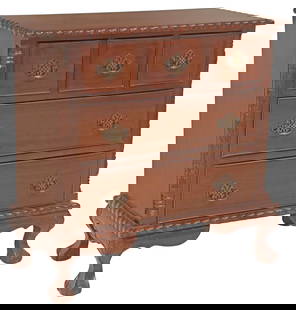 CHIPPENDALE STYLE CARVED MAHOGANY CHEST OF DRAWERS: Chippendale style hand carved mahogany chest of drawers, late 20th c., having rectangular top with molded edge, three drawers above two additional drawers, pierced metal batwing pulls, flanked by carv