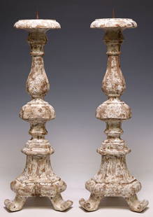 (2) DECORATIVE BAROQUE STYLE CAST COMPOSITE WHITE-PAINTED CANDLE PRICKETS: (pair) Baroque style cast composite candle prickets, 20th c., each having turned-form standard, rising on scrolled tripartite foot, in an intentionally-distressed white-painted finish, approx 23.75&qu