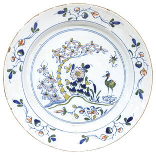 ENGLISH DELFT CHINOISERIE POLYCHROME CHARGER, 18TH C.: English Delft polychrome tin-glazed earthenware charger, late 18th c., painted in blue, red, green and yellow,&nbsp;depicting a&nbsp;Chinese-style landscape with a bird and bamboo,&nbsp;typical small