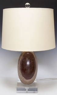 GEOLOGICAL SHIVA LINGAM STONE 1-LIGHT TABLE LAMP: Geological shiva lingam stone, now fashioned as a single-light table lamp, on colorless acrylic base, accompanied by fabric drum shade, observed operating, specimen: approx 10&quot;h, 5.75&quot;diam,