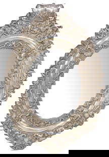 SPANISH COLONIAL STYLE STERLING-CLAD REPOUSSE OVAL MIRROR, 35" X 23.5": Spanish Colonial style sterling-clad repousse wall mirror, 20th c., silver cladding on wood frame, having crown-form crest, above ovular frame with various scrolled foliates and floral motifs, scallop