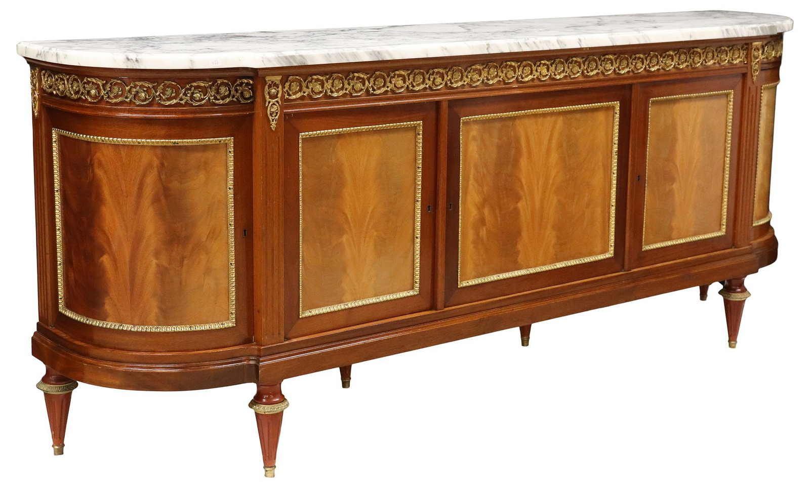FRENCH LOUIS XVI STYLE MARBLE-TOP MAHOGANY SIDEBOARD: French Louis XVI style marble-top mahogany sideboard, 20th c., frieze mounted with gilt-metal rinceau, five cabinet doors, the center left door enclosing four drawers, all other cabinets with an adjus