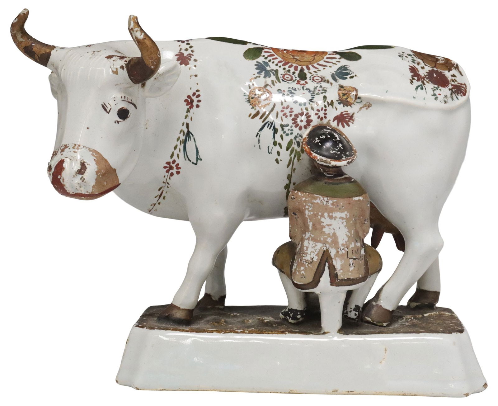 DUTCH DELFT TIN-GLAZED & COLD-PAINTED FIGURE OF A COW, 18TH C.: Dutch Delft tin-glazed earthenware cow and farmer, late 18th c., the cow with cold-painted floral decoration, seated figure in cap and jacket, cow with partial loss to udder, typical small chips and l