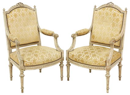 (2) FRENCH LOUIS XVI STYLE PAINTED & UPHOLSTERED FAUTEUILS: (pair) French Louis XVI style painted-decorated armchairs/ fauteuils, early 20th c., having ribbon crest flanked by turned finials, above padded back, seat, and armrests in mustard relief-patterned ja