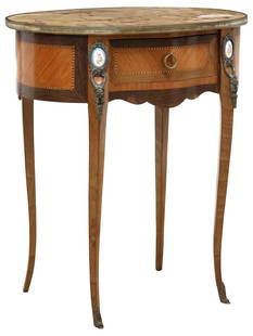 FRENCH LOUIS XV STYLE MARBLE-TOP MAHOGANY PORCELAIN-MOUNTED SIDE TABLE: French Louis XV style mahogany side&nbsp;table, 20th c., having inset ovular marble top, above single drawer, framed string inlay and mounted porcelain plaques,&nbsp;rising on transitional cabriole le