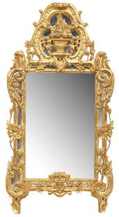 FRENCH REGENCE STYLE GILTWOOD PARCLOSE MIRROR, 49" X 25": French Regence style giltwood and gesso wall mirror, late 19th c., having scrolled crest with central fruit-filled urn, above conforming cushion frame with various floral motifs, encasing flat mirror