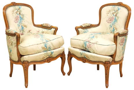 (2) FRENCH LOUIS XV STYLE SILK-UPHOLSTERED BERGERES: (pair) French Louis XV style carved wood armchairs/ bergeres, late 19th c., each in floral-patterned silk upholstery, with nailhead trim, removable down-filled seat cushion, rising on cabriole legs, e