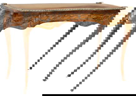 LOUIS XV STYLE LEATHER-TOP INLAID BUREAU PLAT: Louis XV style matched veneer bureau plat/ writing desk, early 20th c., shaped top mounted with foliate-cast gilt metal trim, with gilt-embossed inset leather writing surface, over scrolled apron with