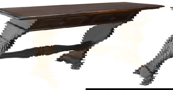 ITALIAN RENAISSANCE REVIVAL CARVED WALNUT LIBRARY TABLE / DESK: Italian Renaissance Revival carved walnut library table/ writing desk, late 19th c., rectangular top over two drawers, rising on stretcher-joined trestle base with carved floral medallions, ending on