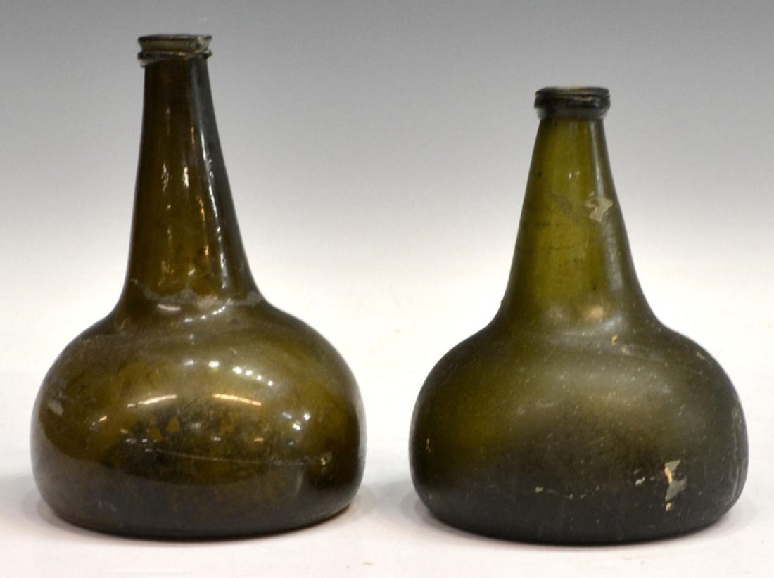 (2) 18TH C. DUTCH ONION FORM OLIVE GLASS BOTTLES: (lot of 2) Onion bottles, Dutch, 17th/18th c., each in olive green, expected hazing, chips to rim, pontil scars, approx 8.25"h, 2.75lbs total **Provenance: found and collected by the consignor on beac