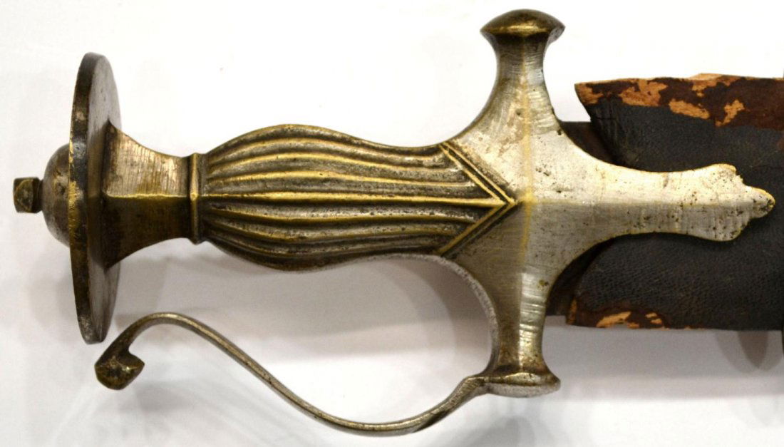 INDO-PERSIAN TALWAR SWORD: Indo-Persian Talwar sword with scabbard, 19th c., curved 30.5" blade, fuller at each side, 6" handle, leather over wood scabbard in poor condition,, overall: 35"l, 3.75"w, 1.5lb Start Price: $100.00