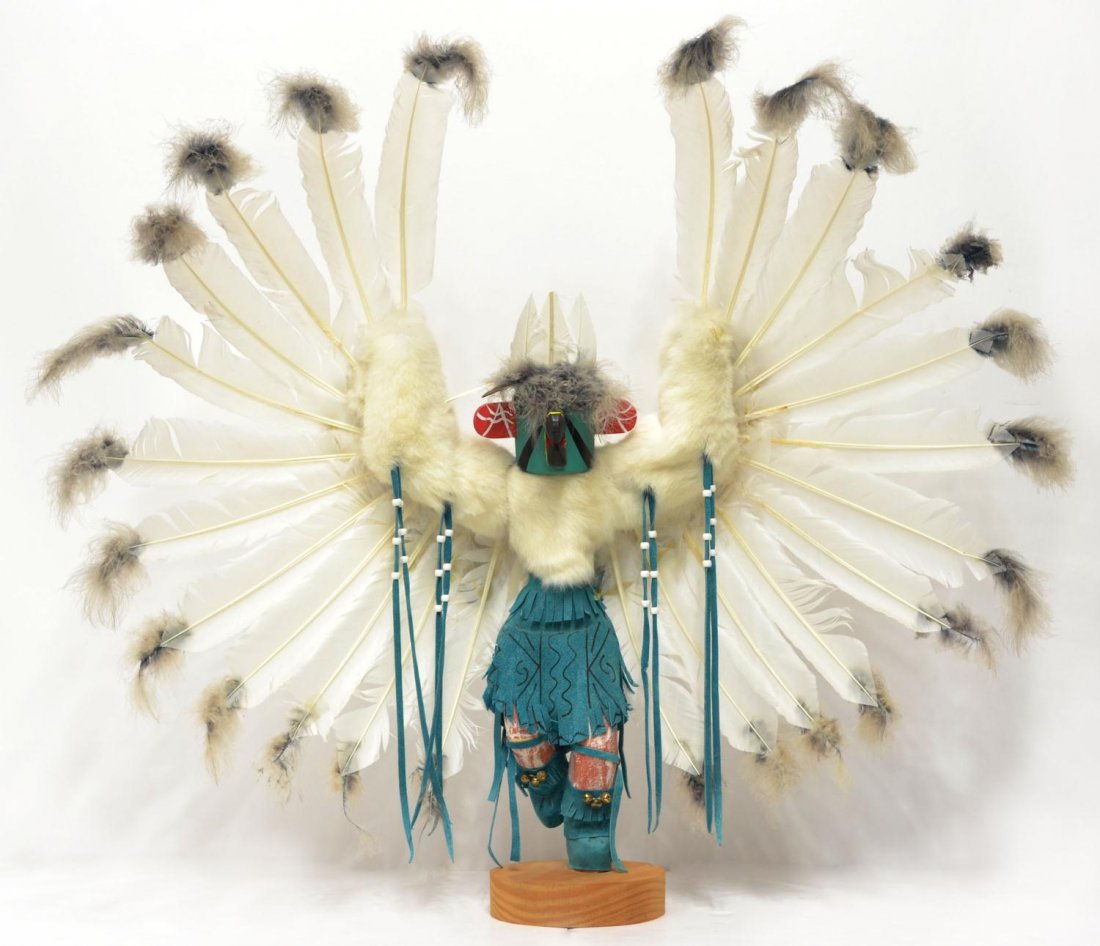 LARGE SOUTHWEST NATIVE AMERICAN KACHINA DOLL: Large Navajo Kachina doll, "Eagle" adorned with turquoise leather, white fur and an feathers, bells to boots, rising on a circular wood base, signed underfoot JCM with Native American tribal census nu