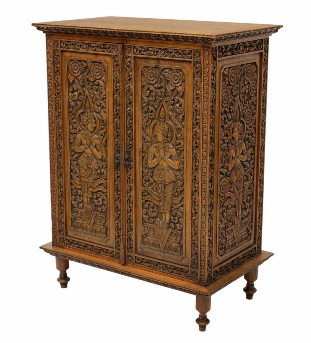 BRITISH COLONIAL ELABORATELY CARVED CABINET: British Colonial two door cabinet, the sides and front covered with foliate and figural carving, raised on turned legs with arrow feet, 46.5"h, 35.25"w, 21.25"d Start Price: $250.00
