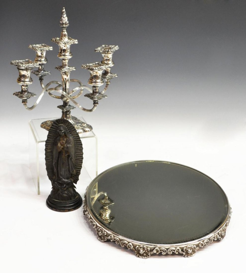 (3) CANDELABRA, MIRROR PLATEAU, RELIGIOUS STATUE: (lot of 3) Collection of table items, comprising: (1) circular mirror top tray, the beveled glass rising on a scrolled floral footed base, 1.5"h, 14.25"diam; (1) five-light silverplate candelabra, E.G