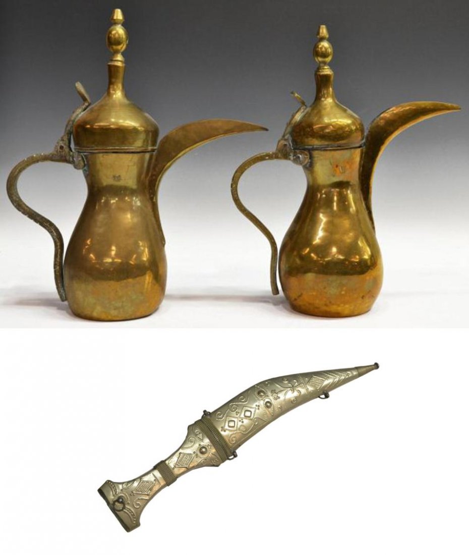 (3) MIDDLE EASTERN BRASS EWERS PITCHERS & KNIFE: (lot of 3) Group of Middle Eastern items, comprising: (2) hand hammered brass ewers, finials surmounting the hinged lids of each baluster form body with large stylized spouts, stamped as pictured, one