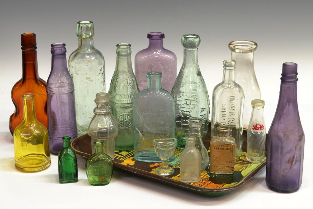 (20) COLLECTION OF VINTAGE & ANTIQUE GLASS BOTTLES: (lot of 20) Collection of vintage and antique glass bottles, including, soda, medicine and perfume bottles in amethyst, colorless and green tones, some with chips, largest: 9"h, together with a vintag