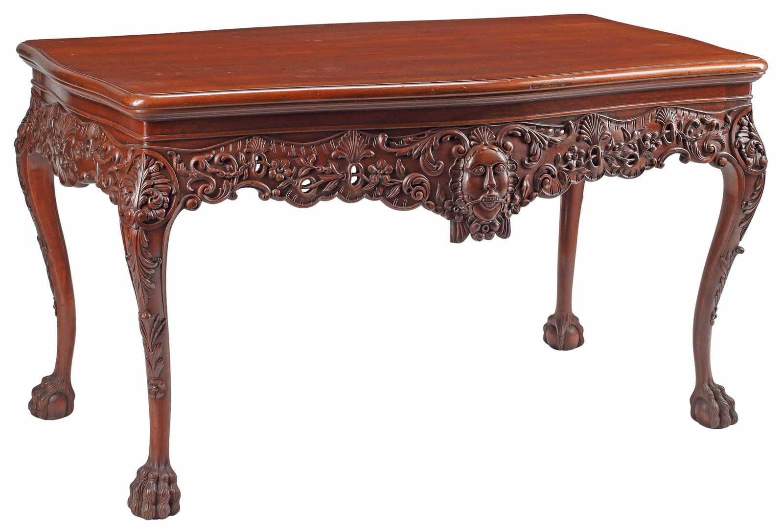GEORGE II STYLE CARVED MAHOGANY LIBRARY TABLE: George II style carved mahogany library or center table, in the style of William Kent (English, c.1685-1748), 20th c., having shaped top, above pierced scrollwork apron with central mask, rising on ca