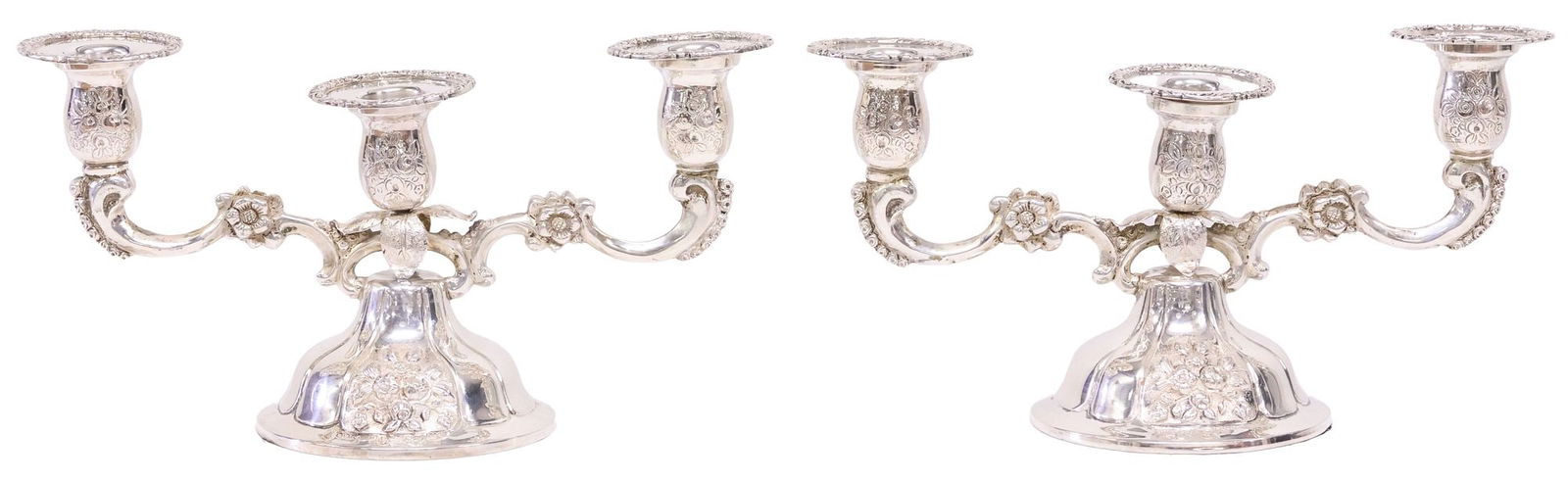 (2) GERMAN STERLING SILVER WEIGHTED CONVERTIBLE CANDELABRA: (pair) German handwrought sterling silver candelabra, with weighted bases, scroll branches supporting three candle sconces with detachable nozzles, on a domed base with chased flowers, convertible to
