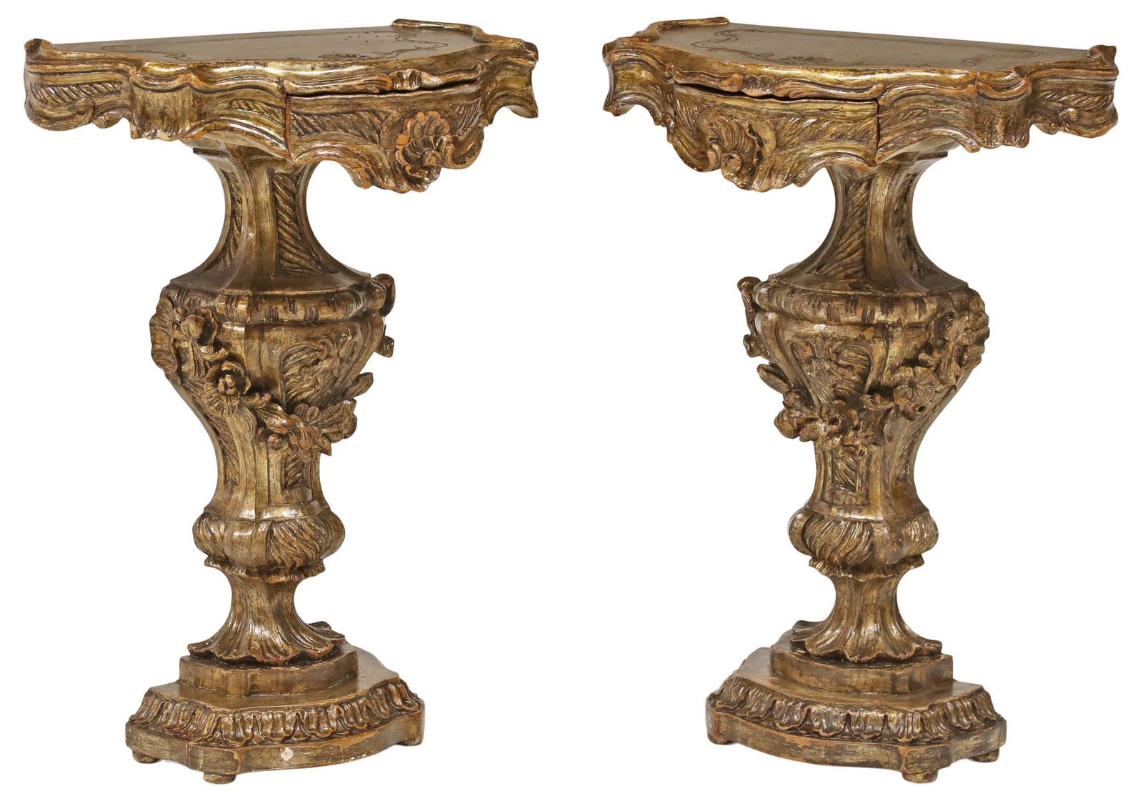 (2) ITALIAN VENETIAN SILVERED GILTWOOD WALL BRACKET CONSOLE TABLES: (pair) Italian Venetian silvered giltwood wall brackets, early 20th c., shaped top with incised scrollwork and shell motif, over single drawer, raised on urn-form standard with floral swags, endi