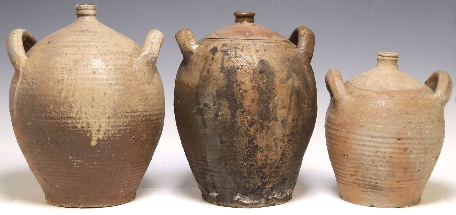 (3) FRENCH PROVINCIAL STONEWARE OIL JUGS: (lot of 3) French Provincial stoneware oil jugs, each with dual side handles over tapered body, largest: approx 14"h, 10.5"w, 10.25"d, 23.75lbs total