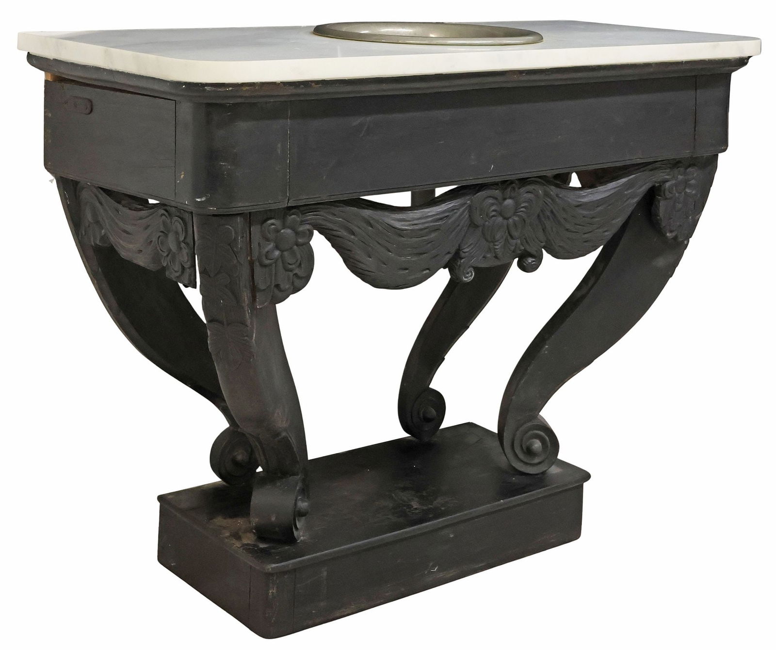 BLACK-PAINTED CONSOLE TABLE MOUNTED WITH A SINK: Carved wood console table fashioned as a freestanding sink, in a black-painted finish, white marble top with a drop-in sink basin, above carved stylized flowers, on scrolled supports, approx 35.75"h,