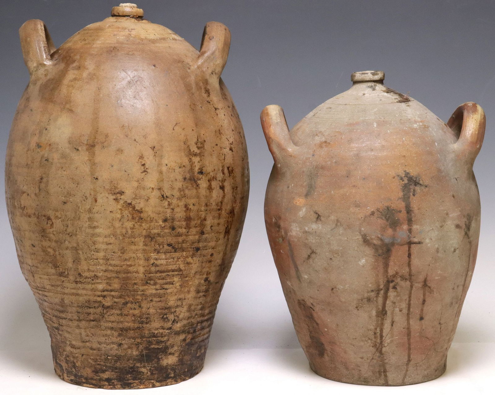 (2) LARGE FRENCH PROVINCIAL STONEWARE OIL JUGS: (lot of 2) Large French Provincial stoneware oil jugs, each with dual side handles over tapered body, largest: approx 18.5"h, 11"w, 11"d, 30.25lbs total