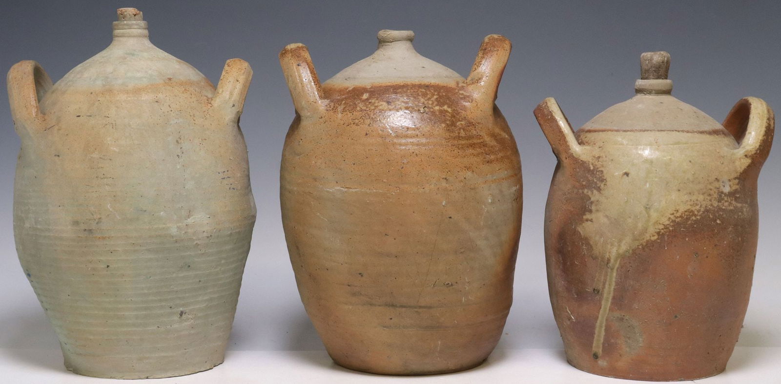 (3) FRENCH PROVINCIAL STONEWARE OIL JUGS: (lot of 3) French Provincial stoneware oil jugs, each with dual side handles over tapered body, all with denting to sides, largest: approx 13"h, 8"diam, 24lbs total