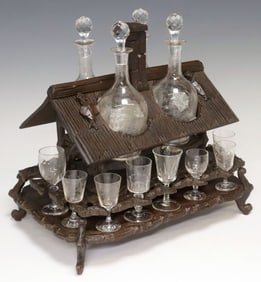 BLACK FOREST CARVED WALNUT HOUSE-FORM TANTALUS SET