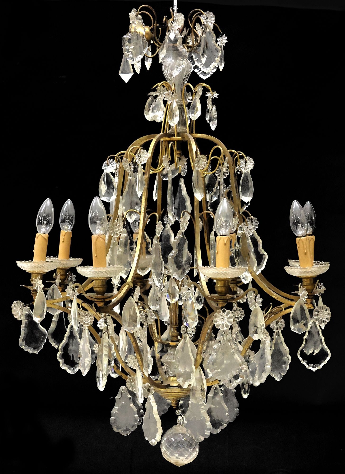 FRENCH GILT-METAL & CRYSTAL 8-LIGHT CHANDELIER: French gilt-metal and crystal eight-light chandelier, 20th c., having fluted molded glass standard, over scrolled gilt-metal frame hung with faceted crystal drops, pendalogues, and molded floriforms,