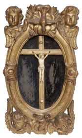 ITALIAN CARVED CRUCIFIX IN OVULAR GILTWOOD CHERUB FRAME