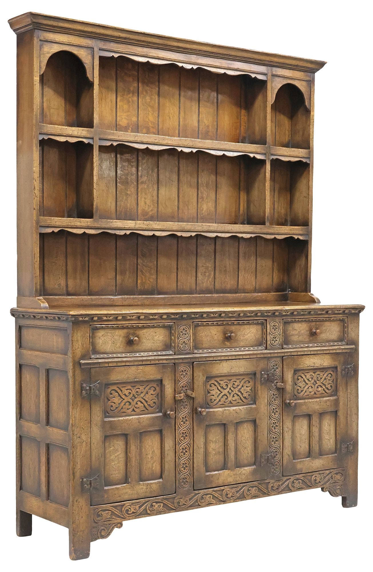 ENGLISH CARVED OAK KITCHEN DRESSER: English carved oak kitchen dresser, 20th c., molded cornice, open shelves with plate ledges, lower section with three drawers, over three paneled cabinet doors, enclosing a fixed-height shelf, approx 