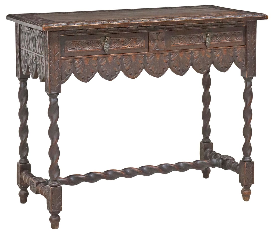 ENGLISH JACOBEAN STYLE CARVED OAK HALL TABLE: English Jacobean style oak hall/ console table, late 19th c., having rectangular top with carved border and beveled edges, over two drawers, with grape bunch pulls, above apron in repeating arch patte
