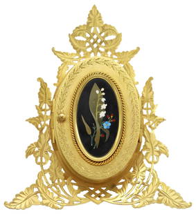 VICTORIAN GILT-BRASS & PIETRA DURA TRIPLE PICTURE FRAME: Victorian gilt-brass triple picture frame, retailed by J. Edmonds & Company, London, late 19th c., chased and pierced foliate border, front cover inlaid with an oval Derbyshire black marble and